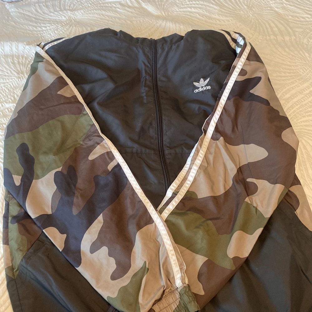 A camouflage Adidas windbreaker in size medium.